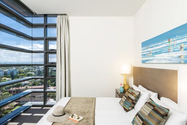 large bed in 2 bedroom apartment with Foxtel on TV and wi-fi at Mon Komo Hotel in Redcliffe