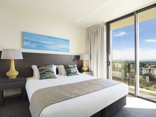 air conditioned bedroom in 3 bed apartment with wi-fi and balcony with views of Redcliffe at Mon Komo Hotel near airport