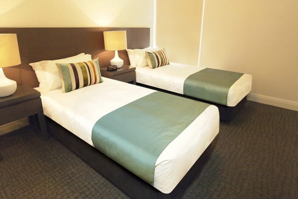 two single beds in air conditioned hotel room with Wi-Fi at Mon Komo Hotel in Redcliffe