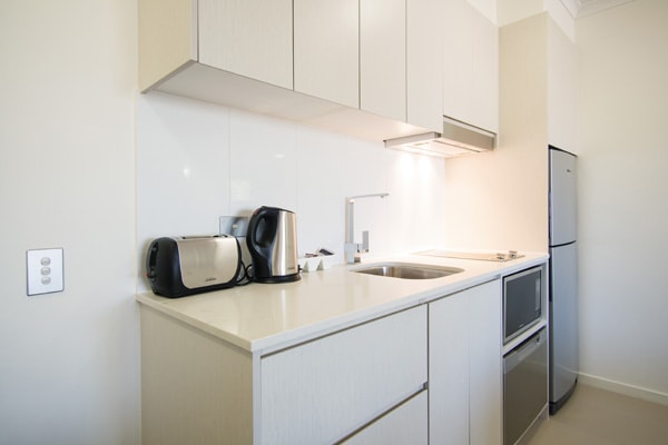 kitchenette in one bedroom executive apartment with large fridge, microwave, toaster and kettle at Oaks Oasis Resort hotel in Caloundra, Sunshine Coast