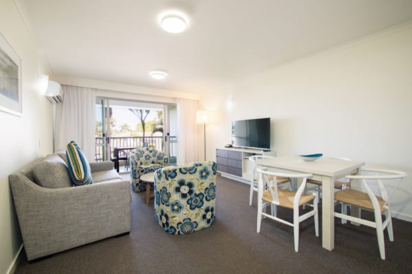 Caloundra hotels living room with TV and Foxtel in air conditioned one bedroom executive apartment ideal for corporate travellers visiting Sunshine Coast on business trips