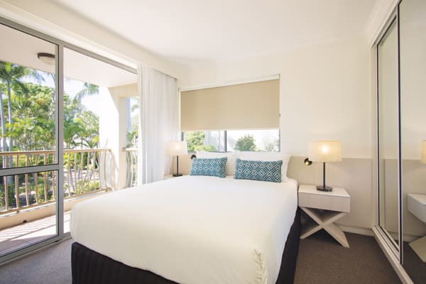 air conditioned bedroom of 2 bedroom apartment with Wi-Fi and private balcony at Oaks Oasis Resort hotel in Caloundra, Sunshine Coast
