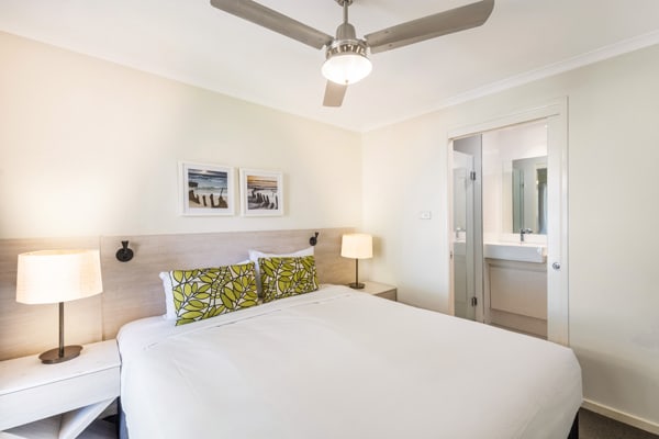master bedroom with en suite bathroom, air conditioning, Wi-Fi and ceiling fan in 3 bedroom villa at Oaks Oasis Resort hotel on Sunshine Coast, Queensland
