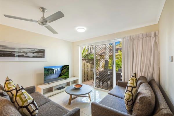 air conditioned living room with TV with Foxtel and comfortable couches in 3 bedroom hotel villa at Oaks Oasis Resort