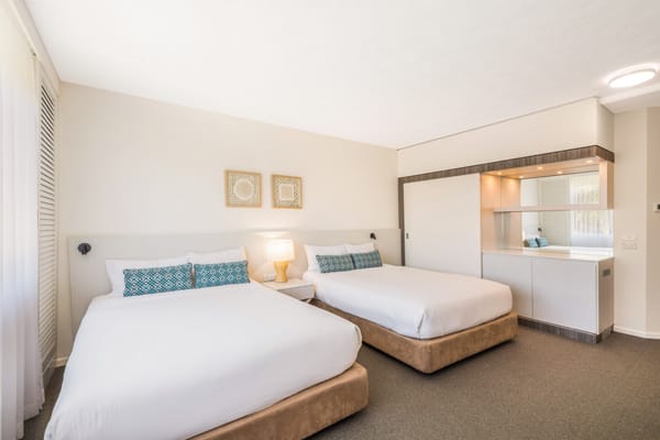 two queen size beds in bedroom with en suite bathroom in Executive Family hotel room at Oaks Oasis Resort in Caloundra on Sunshine Coast, Queensland, Australia