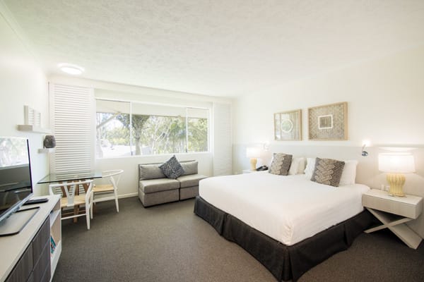 air conditioned bedroom with queen size bed and TV with Foxtel in Executive King hotel room apartment at Oaks Oasis Resort in Caloundra on Sunshine Coast, Queensland, Australia