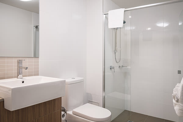 en suite bathroom with large, disabled access shower and toilet at Oaks Rivermarque hotel in Mackay, Queensland, Australia