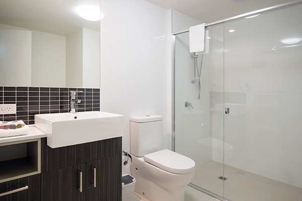 en suite bathroom with shower and toilet in two bedroom apartment at Oaks Rivermarque hotel in Mackay, Queensland, Australia