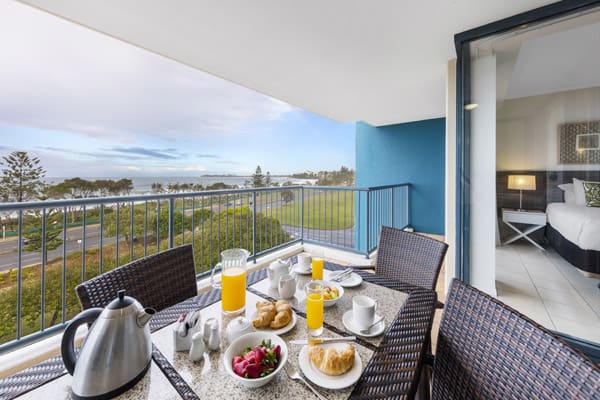 table with healthy breakfast on private balcony of 2 bedroom ocean view apartment walking distance from the beach at Oaks Seaforth Resort hotel, Sunshine Coast