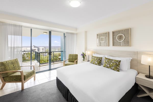 Sunshine Coast resorts with balcony and queen size bed, comfortable couch in air conditioned 3 bedroom apartment at Oaks Seaforth Resort hotel, Sunshine Coast, Queensland, Australia