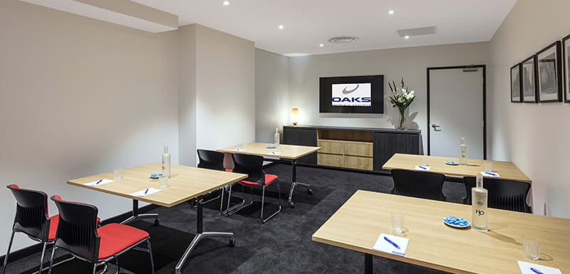 4 tables in large, air conditioned conference room with Wi-Fi for hire in Adelaide city with chairs, TV and catering available