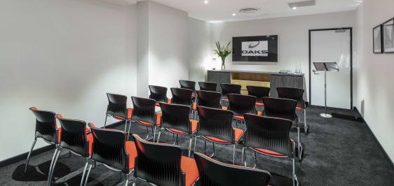 Oaks Embassy Adelaide conferencing room 1 with theater setup with podium, lectern, air conditioning and Wi-Fi access