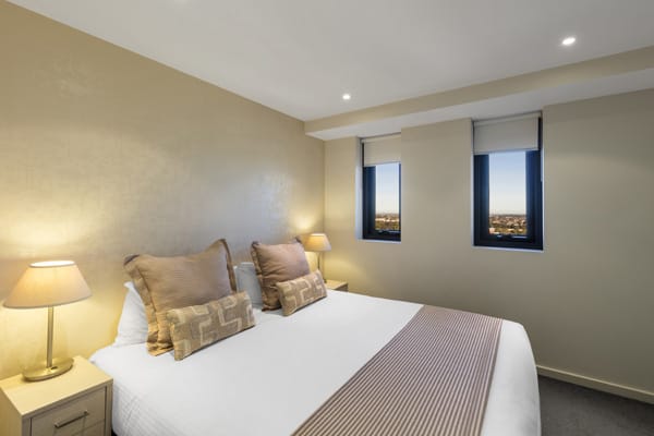 queen size bed in air conditioned 1 bedroom hotel apartment with Wi-Fi at iStay Precinct near Adelaide Convention Centre