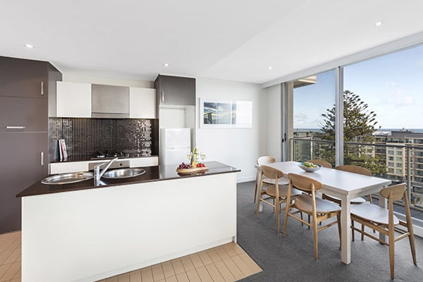 open plan living room and kitchen with air conditioning, Wi-Fi and car parking at Oaks Liberty Towers hotel in Glenelg, South Australia