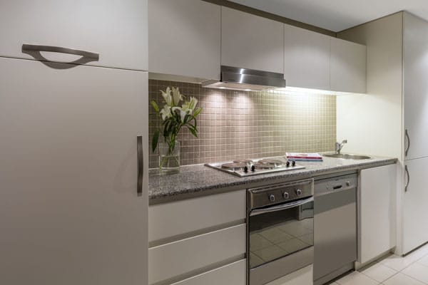 kitchen with oven, stove, big fridge, freezer and air conditioning in 2 bedroom apartment on beach in Glenelg, South Australia