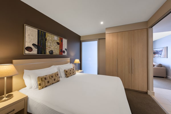 double bed, large wardrobe and en suite bathroom in 2 Bedroom Ocean View Apartment at Oaks Plaza Pier hotel in Glenelg, South Australia