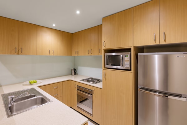 big kitchen with microwave, full-size fridge, large freezer, oven and kettle in 2 Bedroom Executive Apartment with hotel Wi-Fi at Oaks On Lonsdale in Melbourne city, Victoria, Australia
