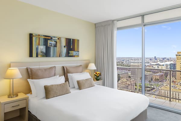 comfortable double bed in air conditioned melbourne hotel apartments, family friendly 3 Bedroom unit with small balcony and Wi-Fi access at Oaks On Lonsdale hotel in Melbourne city centre, Victoria, Australia