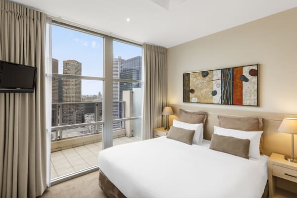 double bed in air conditioned bedroom with Wi-Fi access and Foxtel on TV in Hotel Apartment with private balcony at Oaks On Lonsdale in Melbourne city, Victoria, Australia