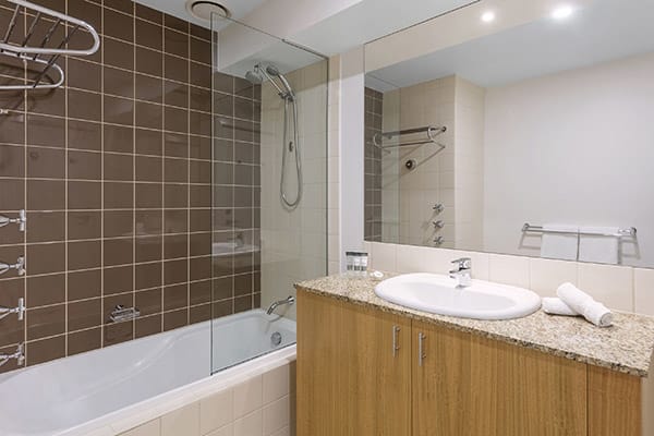 melbourne cbd hotels en suite bathroom of 2 Bedroom Apartment with toilet, shower and mirror at Oaks on Market hotel in Melbourne city, Victoria, Australia