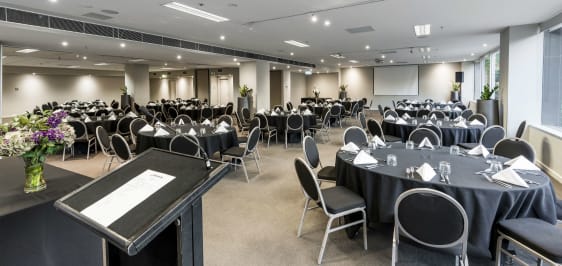 front of event room for hire ready for conference with tables, chairs and large speakers in Melbourne city