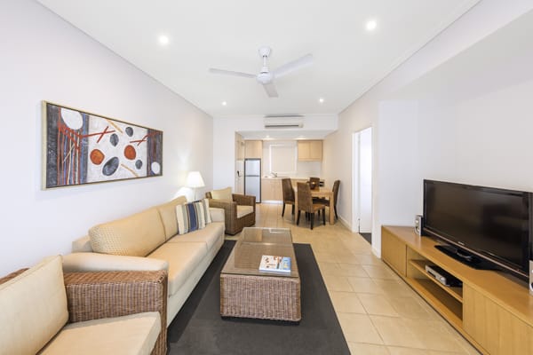air conditioned living room of Broome hotels 1 bedroom apartment with Foxtel on TV and modern furniture in Western Australia