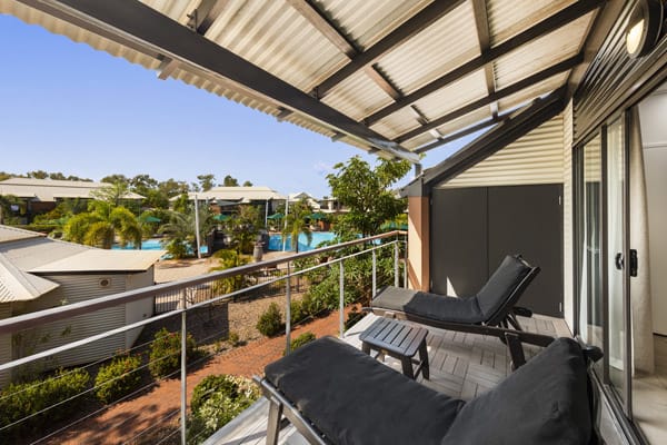 table, chairs and sun loungers in sunshine on large private balcony of Cable Beach Accommodation 1 Bedroom Apartment at Oaks Cable Beach Sanctuary hotel in Broome, Western Australia