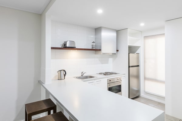kitchen with big fridge, freezer, microwave, kettle and toaster for hotel guests staying in a 2 Bedroom Apartment at Oaks Cable Beach Sanctuary in Broome, Western Australia