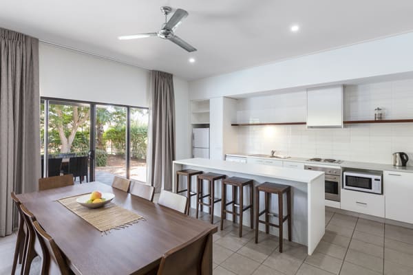 large open plan dining room and kitchen in Cable Beach Hotels with modern applicances including oven, microwave and stove in 3 Bedroom Villa at Oaks Cable Beach Sanctuary hotel in Broome, Western Australia