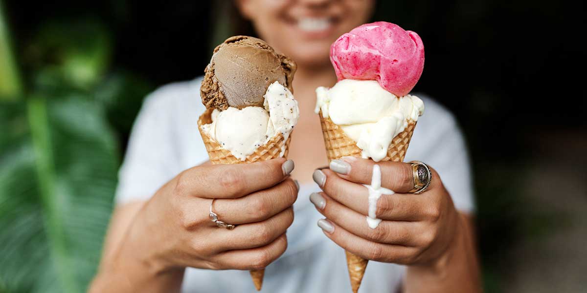 A girl handling two ice creams from the Daintree Ice Cream Factory