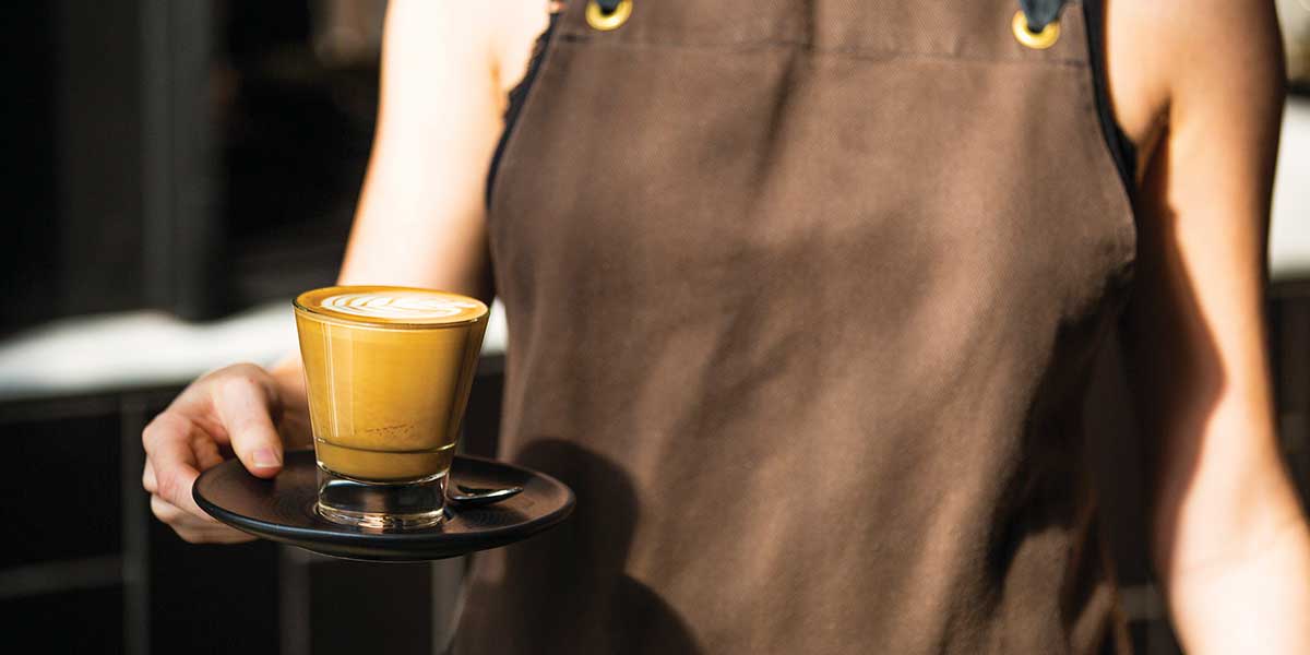 A staff serving hot coffee