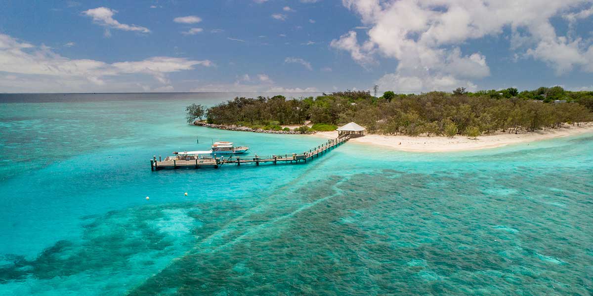 Top view of the Heron Island with majestic view of the large coral reef, blue water, and white fine sand