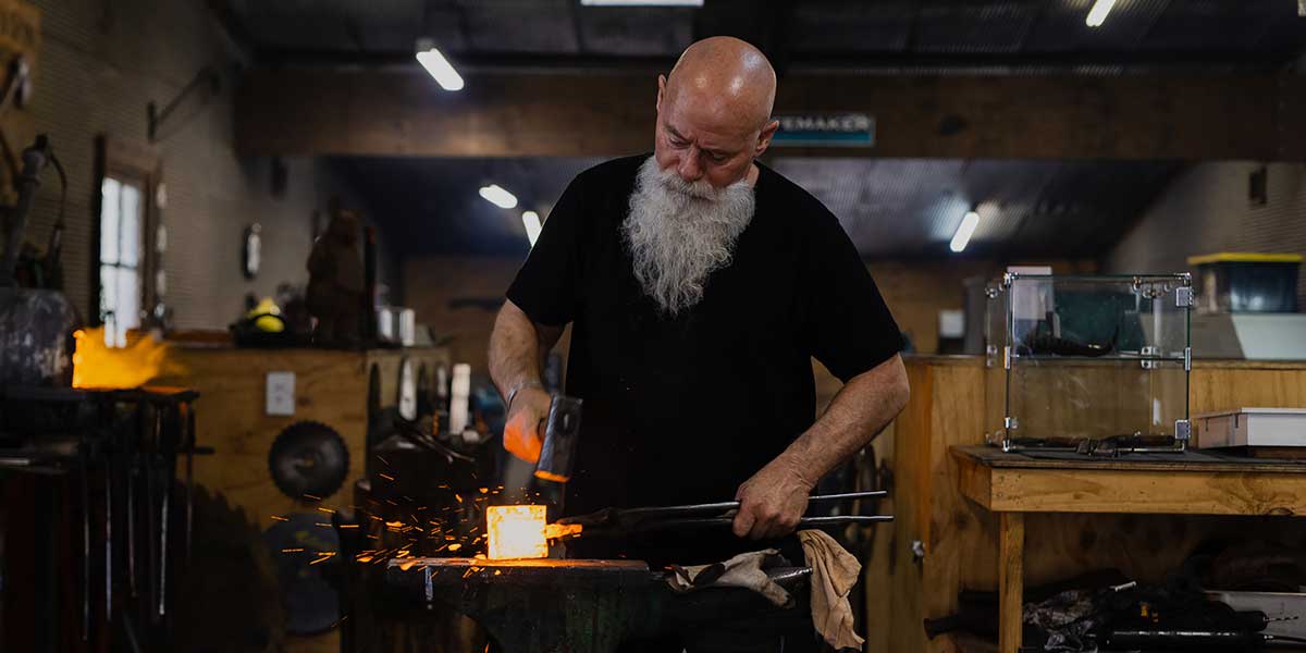 A man creating artisan pieces at the Jam Factory Adelaide