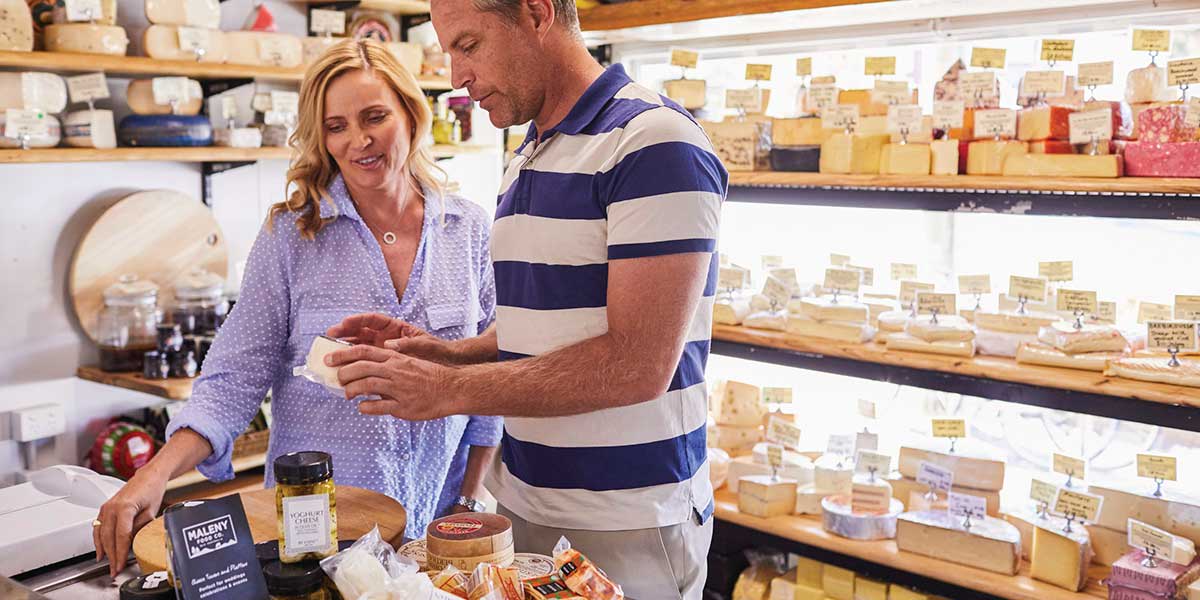 Customers inside Maleny Food Company cheese store picking locally produced cheeses and full cream milks
