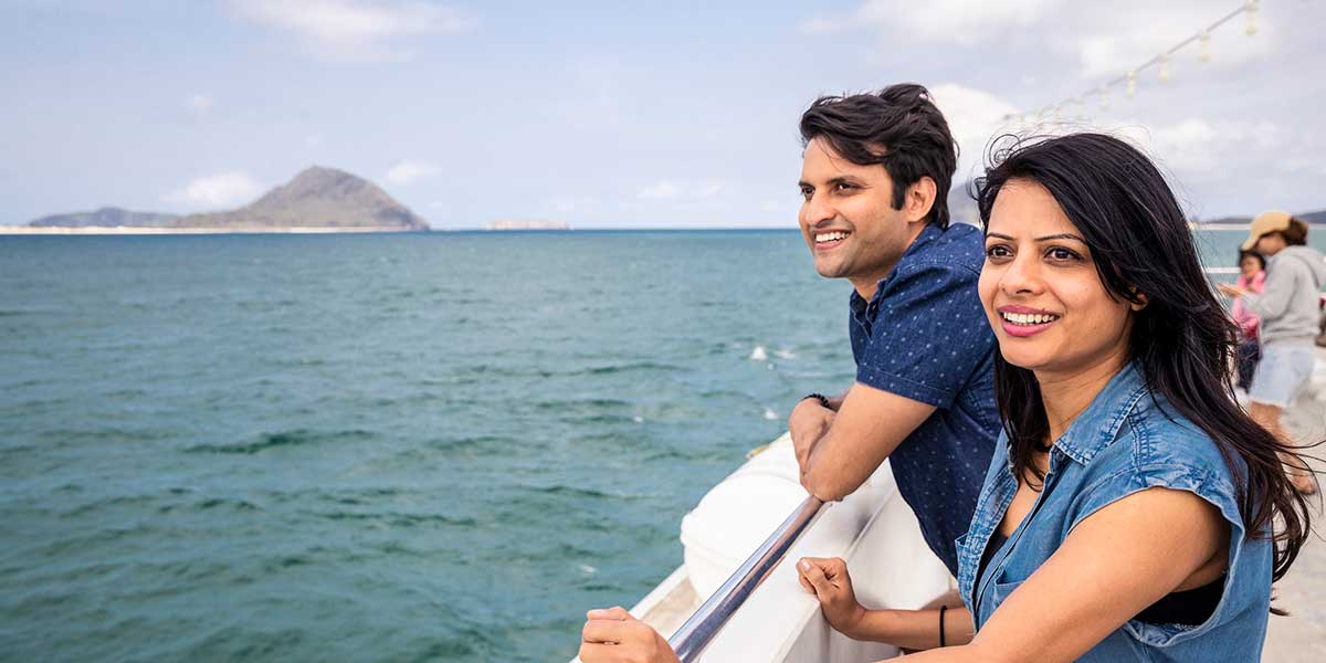 Couple watching the stunning view on the water from the Moonshadow Dolphin Watch Cruise at the Port Stephens New South Wales