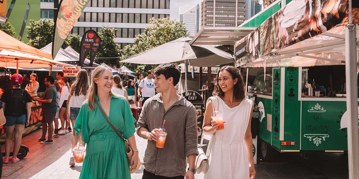 Group of friends walking along the Brisbane City Markets