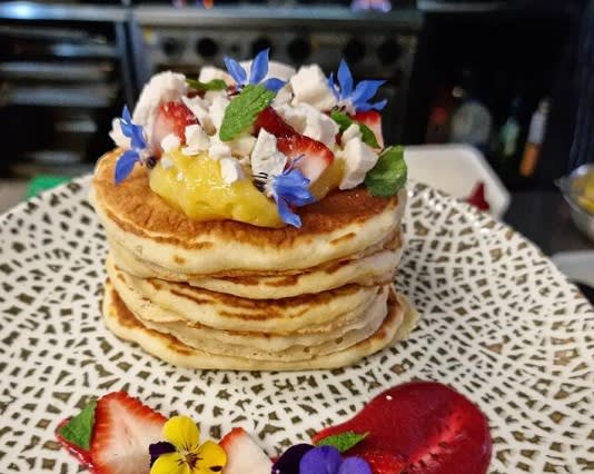 Layers of pancake with fruits on top at Elliott’s Bistro, Alexandra Headland