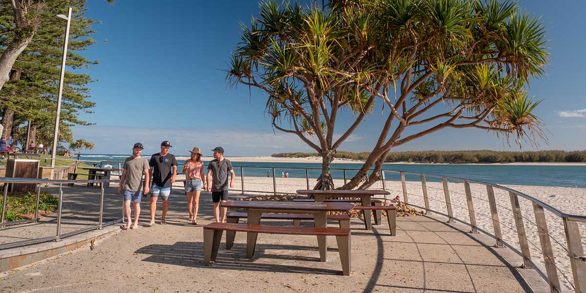 Group of friends walking along the stretch of the Caloundra Coastal Pathway