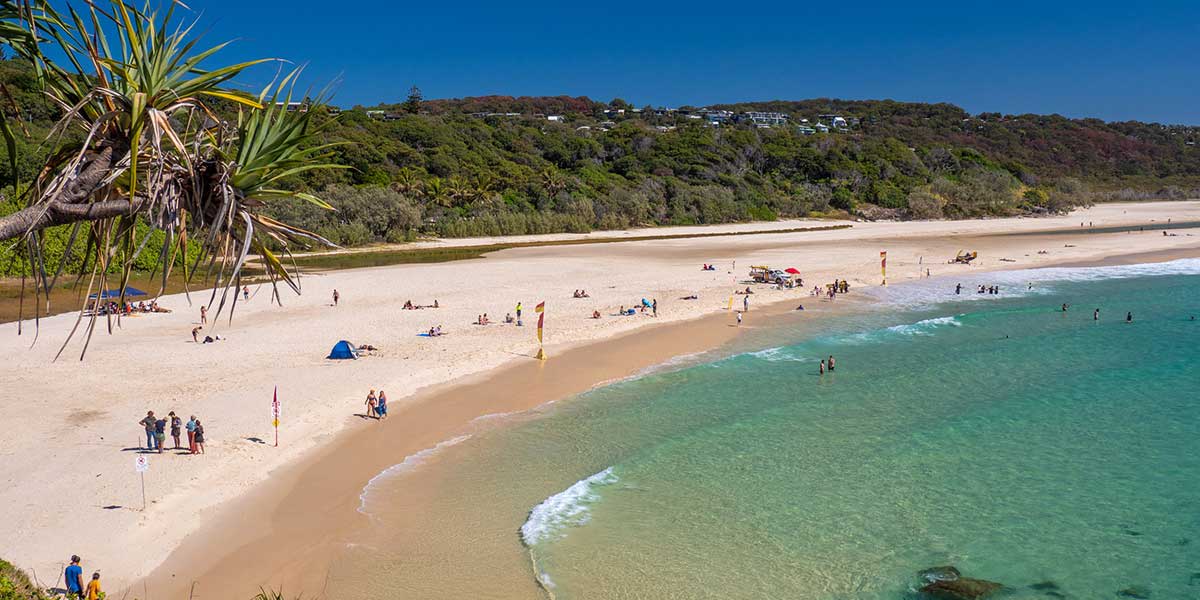 Stradbroke Island's cylinder beach with golden sand and blue waters in Brisbane Queensland