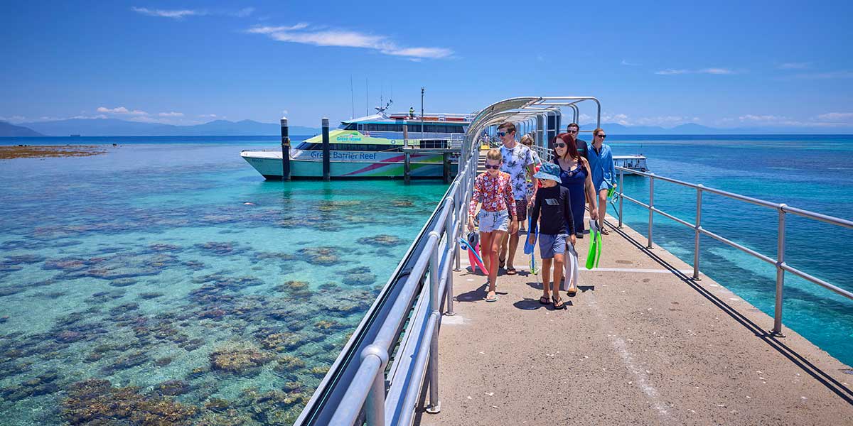 Tourists taking their way to a boat trip to spend a relaxing few hours exploring the forest, snorkeling off the beaches or relaxing on the bays.