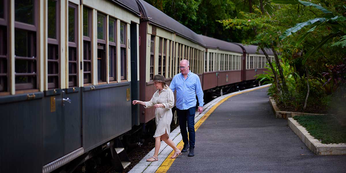 A couple jumped aboard the Kuranda Scenic Railway winding through ancient forest, passing through 15 hand-cut tunnels and across 37 bridges.