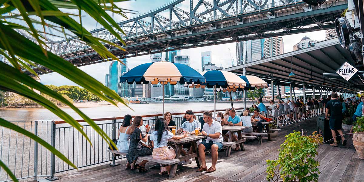 Brisbane Felons' Brewing Co. with a view at the Brisbane Quarter or Howard Smith Wharves with people eating at the al fresco.