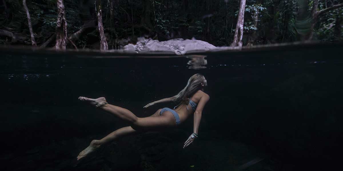 A girl swimming in the clean waters of Stoney Creek Falls