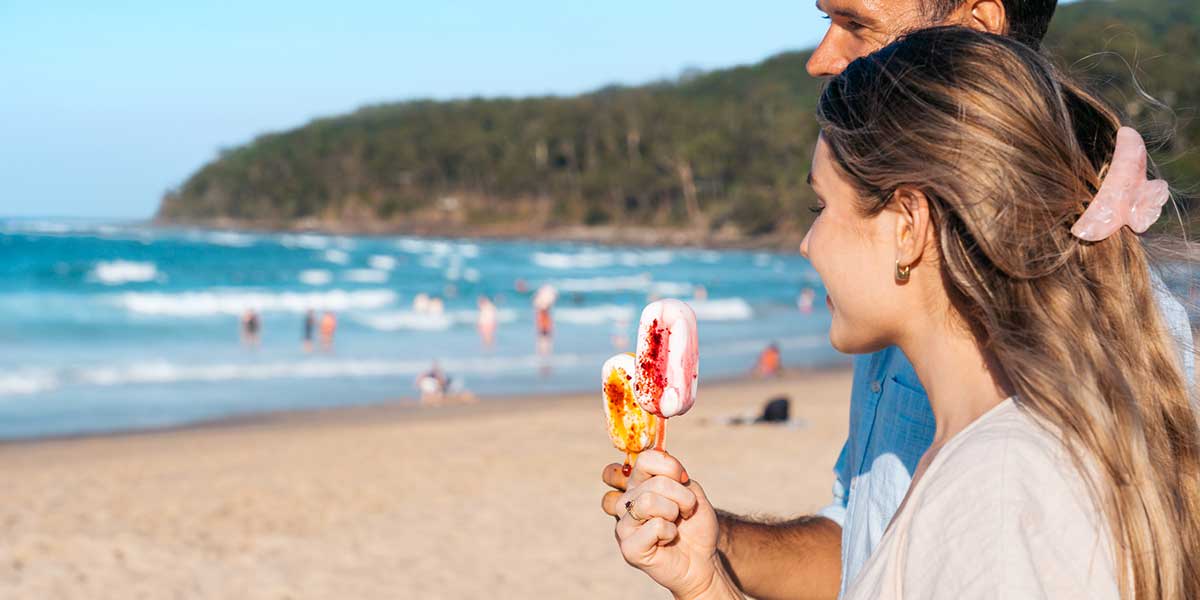 Girl eating ice cream while watching the waves