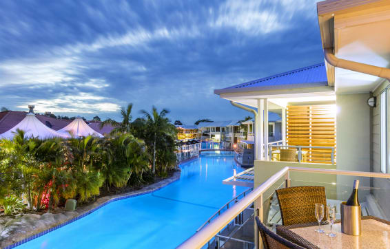 Best Port Stephens hotels balcony overlooking large pool at dusk during summer holidays in New South Wales, Australia