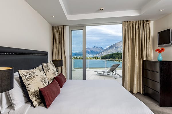 comfortable double bed in bedroom with Netflix and Sky TV in 2 Bedroom Apartment with Wi-Fi access at Oaks Club Resort hotel in Queenstown, New Zealand