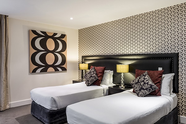 two comfortable single beds for kids with clean sheets in family friendly 3 Bedroom Apartment at Oaks Club Resort hotel in Queenstown, New Zealand
