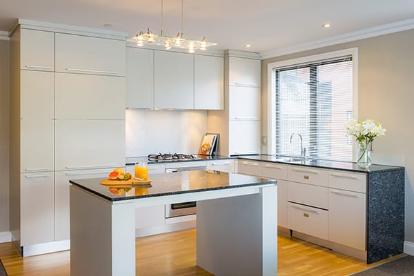 large open plan kitchen with refrigerator, freezer, oven, microwave, kettle and toaster for guests staying in a 1 bedroom hotel apartment at Oaks Shores resort in Queenstown, New Zealand