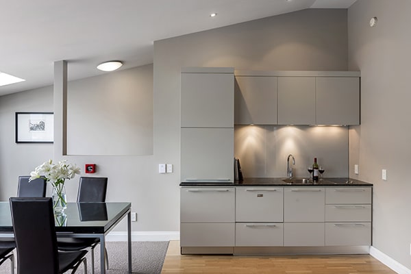 Queenstown resort holiday apartment with kitchenette featuring microwave, kettle, toaster and dining table for couples enjoying a romantic winter holiday in Queenstown, New Zealand