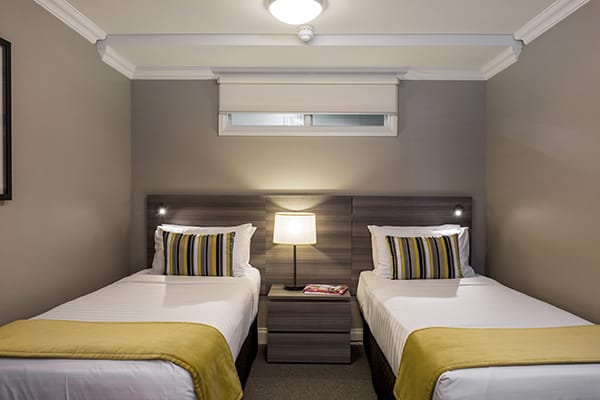 two single beds for kids in family friendly 2 bedroom holiday apartment with Sky TV and Wi-Fi at Oaks Shores hotel in Queenstown, New Zealand